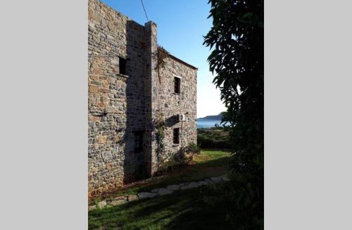 Gortyna House | Traditional stone house by the sea.